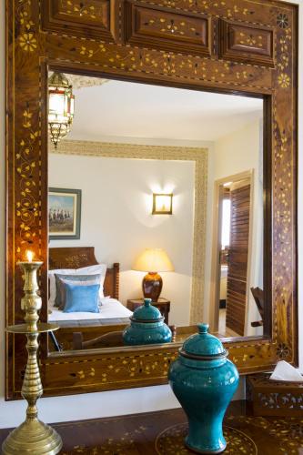 a bedroom with a large mirror and a bed at Villa Quieta in Essaouira