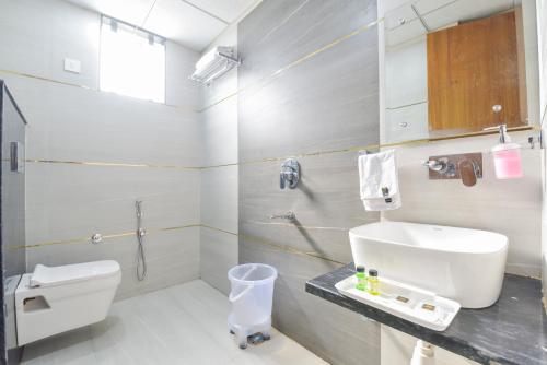 a bathroom with a white toilet and a sink at INDRA PALACE Unit 2 in Jaipur