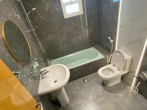 a bathroom with a sink toilet and a mirror at Coral Bay 1 Bedroom apartment