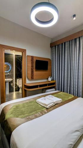 a bedroom with a large bed and a television at Coral Bay 1 Bedroom apartment