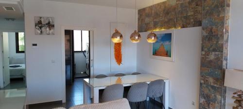 a dining room with a white table and chairs at Royal Park Green Spa in Orihuela Costa