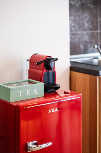 a red refrigerator in a kitchen next to a sink at Bindarella ai Navigli in Milan