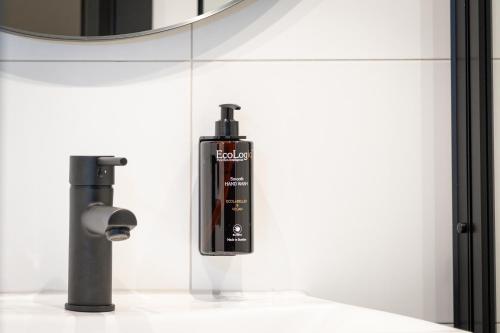 a black soap bottle on a counter in a bathroom at Quality Hotel Grand Steinkjer in Steinkjer
