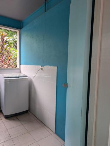 a bathroom with a toilet and a window at Naghoniara Airport Transit in Honiara