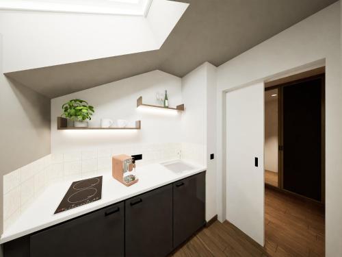 a kitchen with a white counter and a sink at Churfürstenhof Wellnesshotel in Bad Birnbach