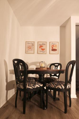a dining room table with two chairs and a bowl on it at Cosy Chester Casa - free parking in Chester