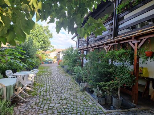 a patio with a table and chairs and plants at Munich Residence in Cristian