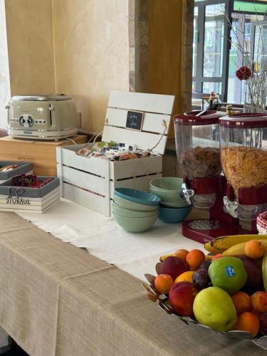 a table with a bowl of fruit on top of it at Casa Merano Residence & Restaurant Bibione - New suites in Bibione