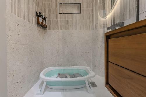 a bathroom with a dog laying in a bath tub at NEW Refurbished Modern Apartment in Barcelona