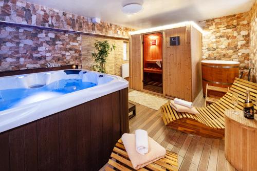 a large tub in a room with two chairs at Apartmány Andrea s wellness in Zdíkov