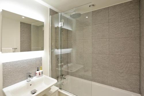 a bathroom with a glass shower and a sink at 3 Bed in Snape oc-2wadd in Snape
