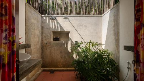 a bathroom with a shower and a toilet and a sink at Coconut Grove - 4 Bed Pool Villa with Cook in Ahangama