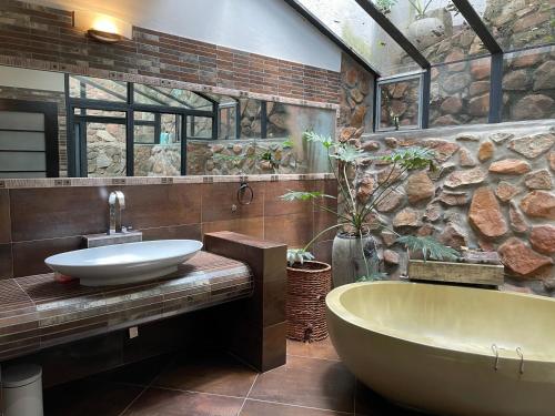 a bathroom with a tub and a sink at Oasis On Lily with OWN Pool in Johannesburg