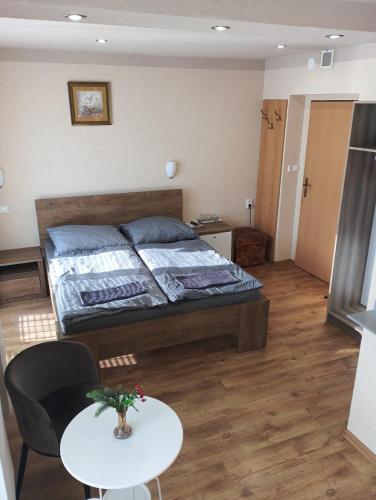 a bedroom with a bed and a table in it at Wellness rezort Maxim Bojnice in Bojnice