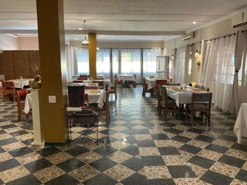 a dining room with tables and chairs in a restaurant at Punyu International Hotel 