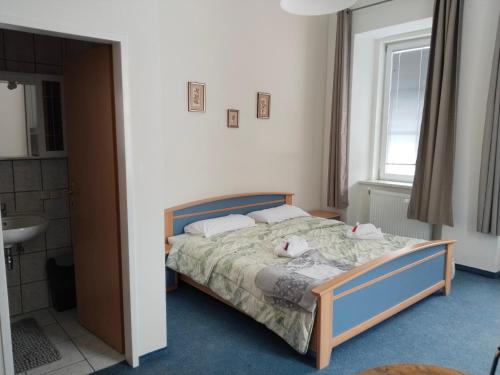 a bedroom with a bed with two stuffed animals on it at Locanda EL TORO in Arnoldstein