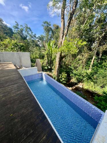 a swimming pool sitting on top of a wooden deck at Tiny House in Dahilayan in Manolo Fortich