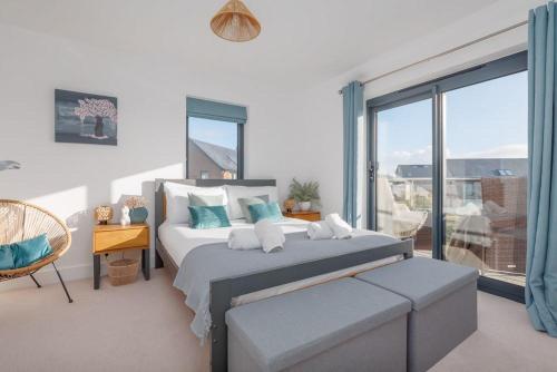 a bedroom with a bed and a large window at Stonehaven in Warmwell