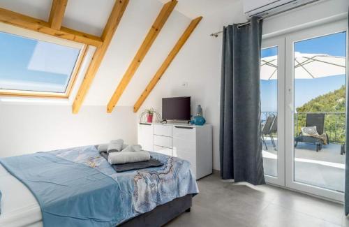 a bedroom with a bed and a sliding glass door at Villa Panorama in Omiš
