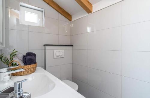 a white bathroom with a sink and a toilet at Villa Panorama in Omiš