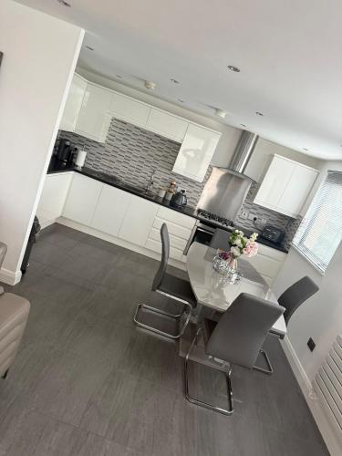 a kitchen with a table and chairs in a room at LUXURY Apartment Belfast City Centre overlooking Custom House Square in Belfast