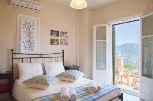 a bedroom with a bed with two towels on it at Homer's View in Stavros