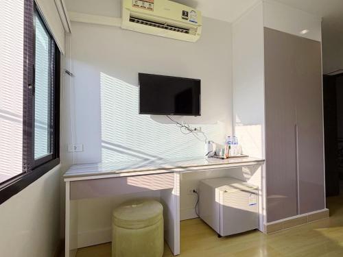 a computer desk in a room with a window at Klongrien Boutique Hotel in Hat Yai