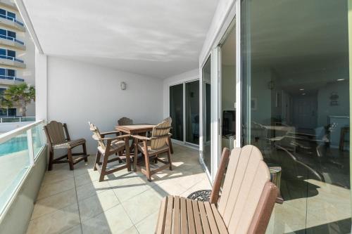 a patio with a table and chairs on a balcony at Silver Beach 104 PET FRIENDLY! in Orange Beach