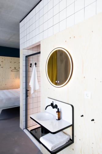 ein Badezimmer mit Waschbecken und Spiegel in der Unterkunft MOLOKO at de Melkhal - just a room - digital key by SMS in Enschede
