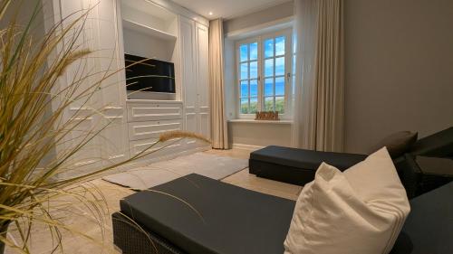 a living room with a couch and a window at LITZKOW 16203 in Archsum