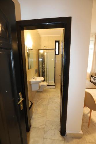 a bathroom with a toilet and a sink at MLR Residence - Free Private Parking in Timişoara