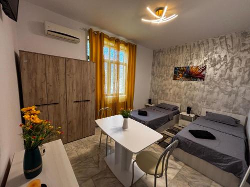 a room with two beds and a table and a room with two beds at MLR Residence - Free Private Parking in Timişoara