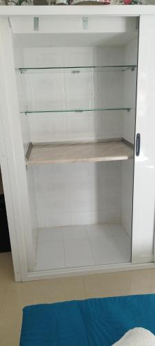 a white cabinet with glass doors in a room at Sunlight house in Marsaskala