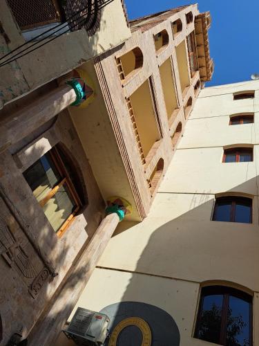an upward view of a building with windows at Thebes Hotel in Luxor