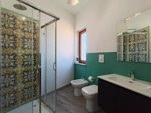 a bathroom with a shower and a toilet and a sink at B&B A' Kiazza in Buompietro