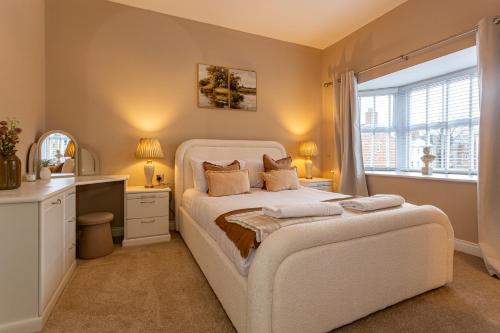a bedroom with a bed and a desk and a window at Kirkwood Drive in Durham