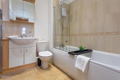 a bathroom with a sink and a toilet and a tub at Kirkwood Drive in Durham