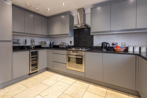 a large kitchen with white cabinets and appliances at Kirkwood Drive in Durham