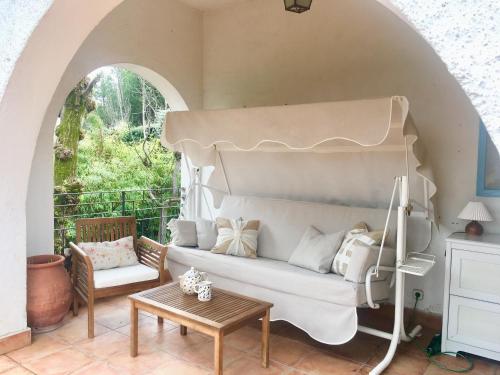 a living room with a couch and a table at Charming villa with a private pool in Las Rozas de Madrid