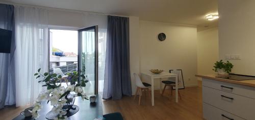 a living room with a table and a dining room at VESTA Apartamenty M52 Free parking in Szczecin