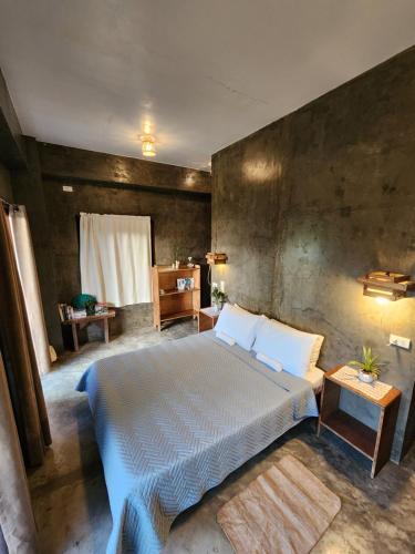 a bedroom with a large bed in a room at Balay Yuhom in General Luna