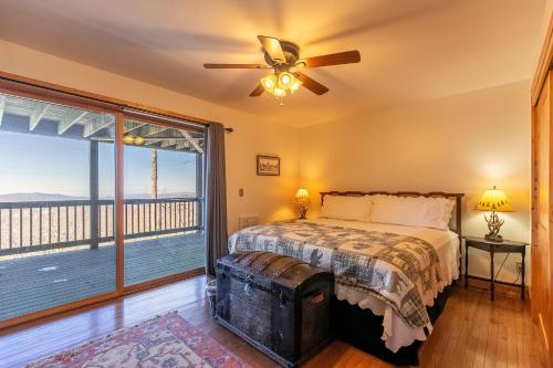 a bedroom with a bed and a large window at Sit Stay Play in Beech Mountain