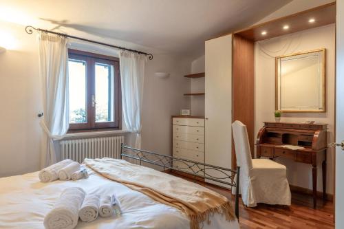 a bedroom with a bed with a mirror and a piano at Italian Experience-Casa Miramonti in Perugia