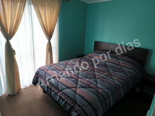 a bedroom with a bed and a large window at Casa Sierra Nevada in Antofagasta