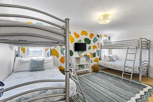 a bedroom with two bunk beds and a tv at Once Upon A Tide in Bolivar Peninsula