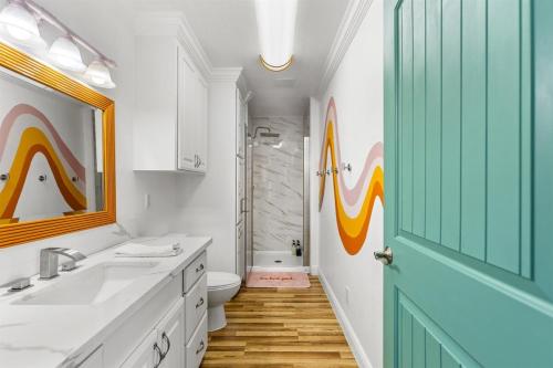 a bathroom with a sink and a toilet and a shower at Once Upon A Tide in Bolivar Peninsula