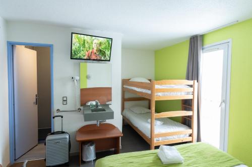 a room with a bed and a sink and bunk beds at Bhoma Budget Troyes aéroport in Troyes