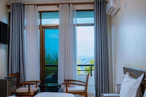a hotel room with a large window with a view at Royal Crown Hotel - Kigali in Kigali