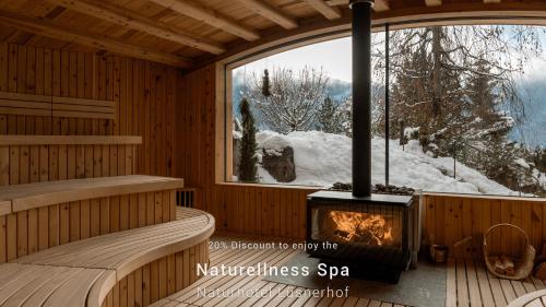 a room with a fireplace in a sauna at Milla Apartments in Bressanone