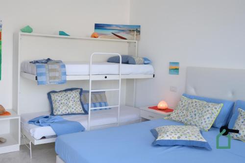 a room with two bunk beds and a bed at Hotiday Room Collection - Torre Lapillo in Torre Lapillo